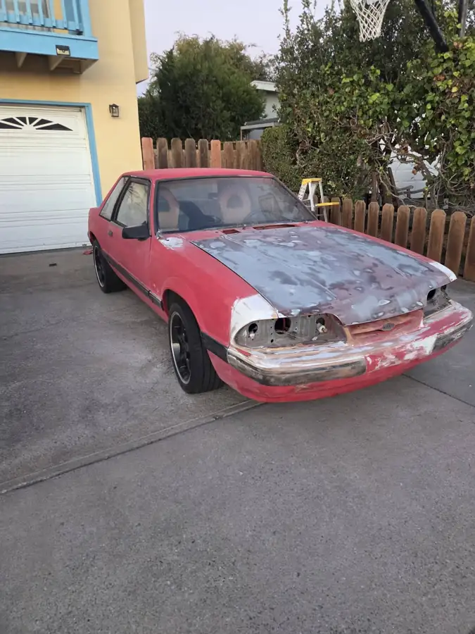 1990 Ford before: faded paint and bare hood